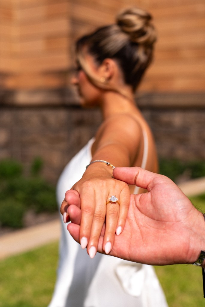 Detail shot of engagement ring on bride-to-be’s hand during a Sydney proposal photoshoot by Veros Photography


